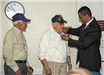 Secretary Francisco Urena presents 75th D-Day pin to Arthur Hubbard and Jack Swymer