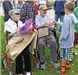 Marjorie and Bernie greeting a boy