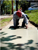 Worker on Hunt street on knees repairing walkway