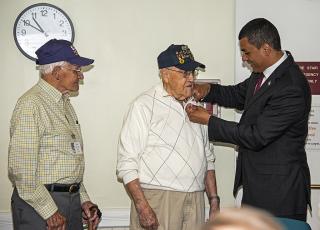 Secretary Francisco Urena presents 75th D-Day pin to Arthur Hubbard and Jack Swymer